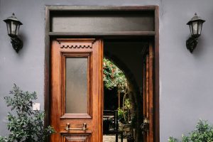 large wooden front doors with frosted vinyl or etched glass windows