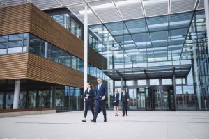 business people walking out of a commercial building